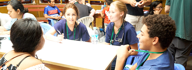 Medical students talking to patient in Latin America